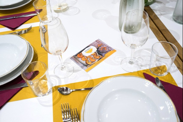 a table set with dishes silverware and glasses for wine and water