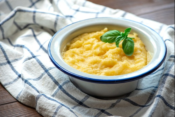 mashed potatoes and basil on a checked kitchen cloth